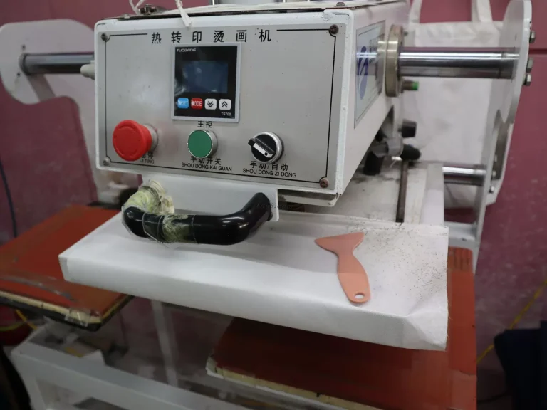 Heat transfer press applying artwork to custom canvas tote bags