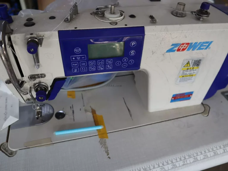 Industrial sewing machine stitching canvas tote bag panels