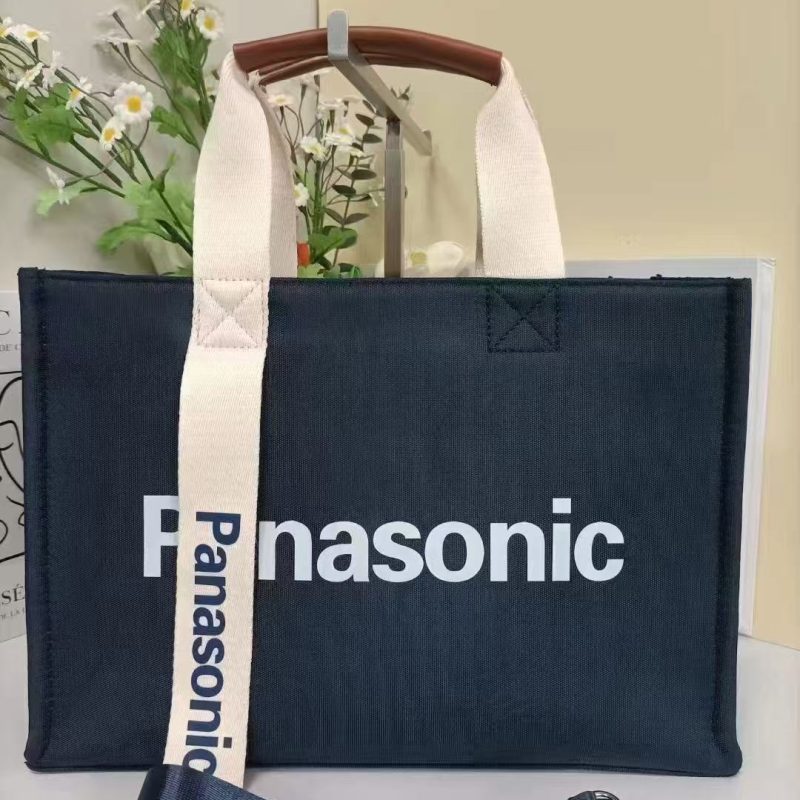 Navy oxford tote bag with cream webbing handles and a detachable navy shoulder strap