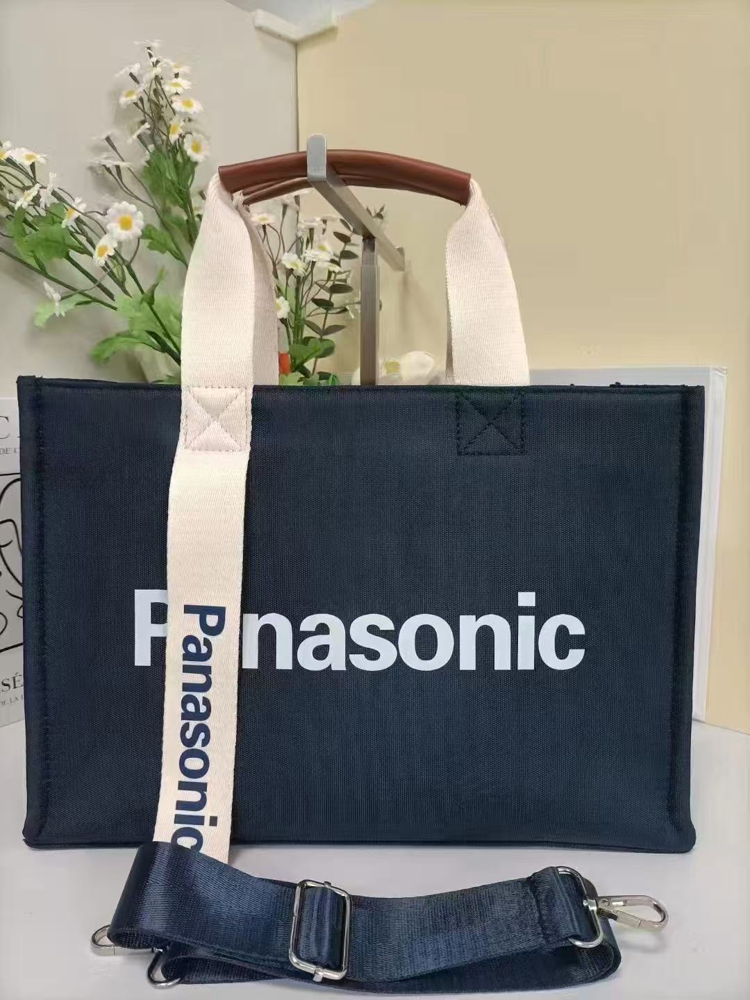 Navy oxford tote bag with cream webbing handles and a detachable navy shoulder strap